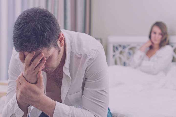 Man with anorgasmia sitting frustrated at the side of his bed