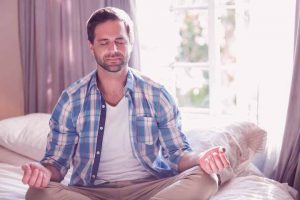 man practicing mindfulness meditation for erectile dysfunction