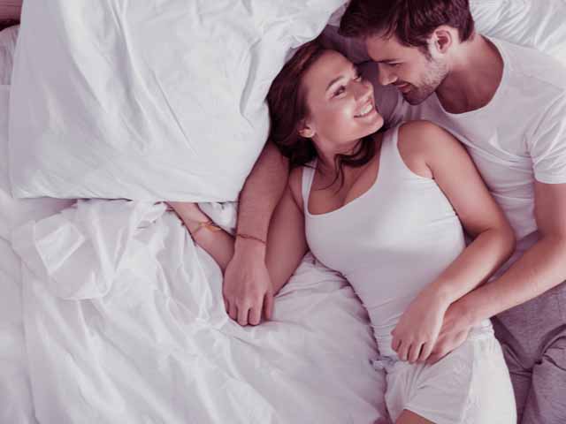 Man in bed happy because he can last longer