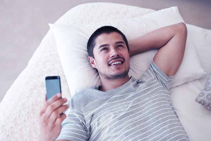 Man reading about premature ejaculation exercises for training yourself to last longer in bed